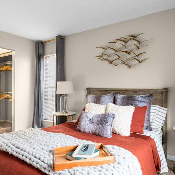 A bedroom with a large bed and a tray with a book on it.