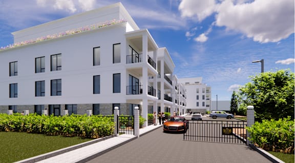 A modern white building with a black gate in front.