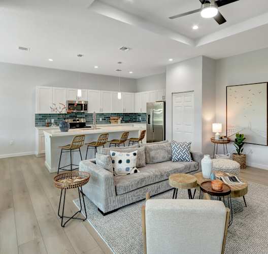 a living room with a couch and a kitchen in the background