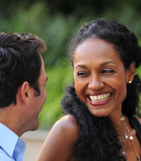 a man and a woman smiling at each other