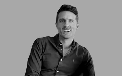a black and white photo of a man laughing