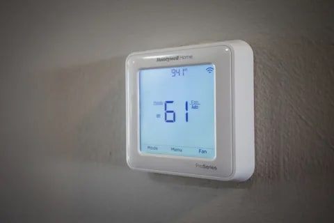 a white thermostat sitting on top of a wall at Avellan Springs Apartments, North Carolina, 27560