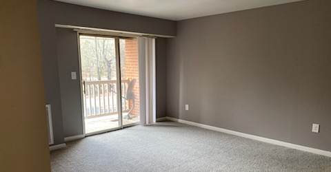 an empty living room with a sliding glass door