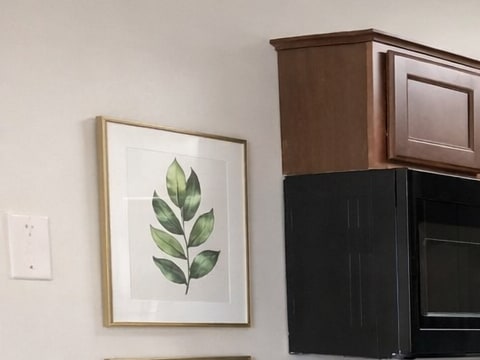 A kitchen with black appliances and wooden cabinets.