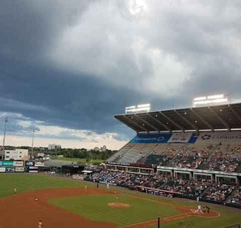 a baseball game is being played on a cloudy day