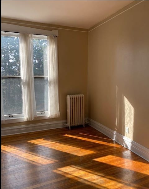 a room with a radiator and two windows