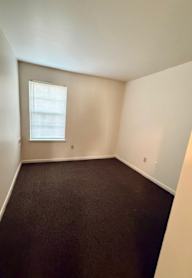 an empty living room with a checkered floor