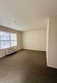 a hallway with a checkered floor and a white door