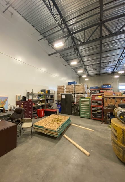 a large warehouse filled with stacks of boxes and other items