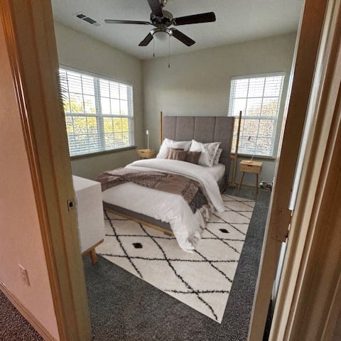 a bedroom with a bed and a ceiling fan