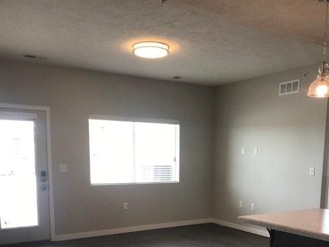 A room with a wooden floor and a window.