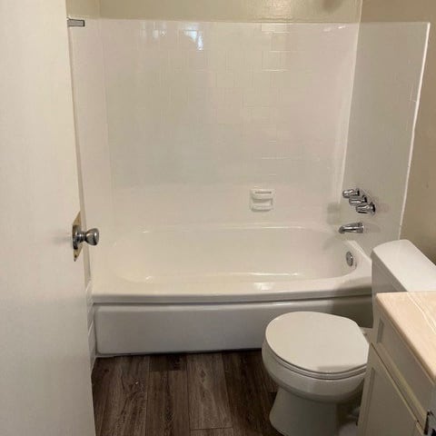 a white bath tub sitting next to a white toilet