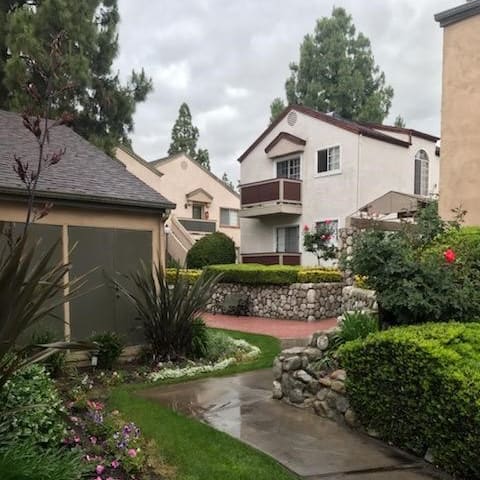 a walkway with a house in the background