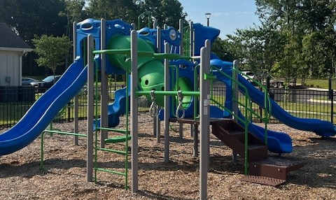 A Playground With a Blue and Green Slide at Arbours at Quincy, Quincy, FL