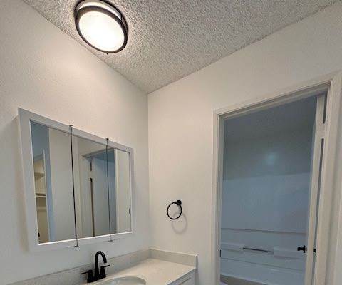 a bathroom with a toilet and a sink and a mirror