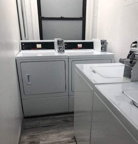 A bathroom with a washer and dryer unit.