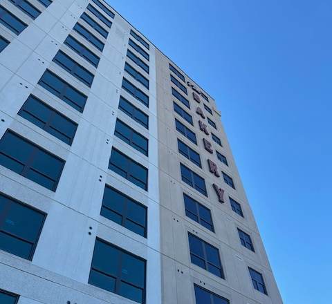 A tall white building with many windows.