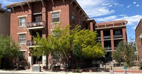 a large brick building on the side of a street