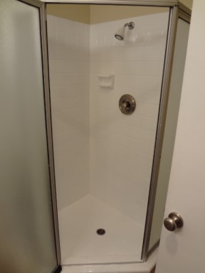 Bathroom with walk-in shower at Villa Knolls Apartments in La Mesa, California.