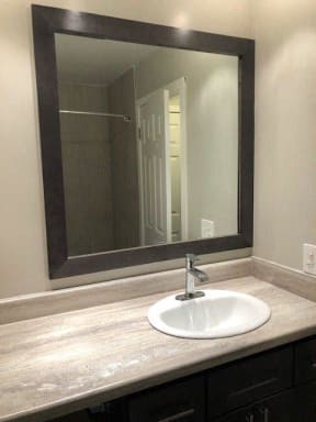 Oversized Countertops & Framed Bathroom Mirror