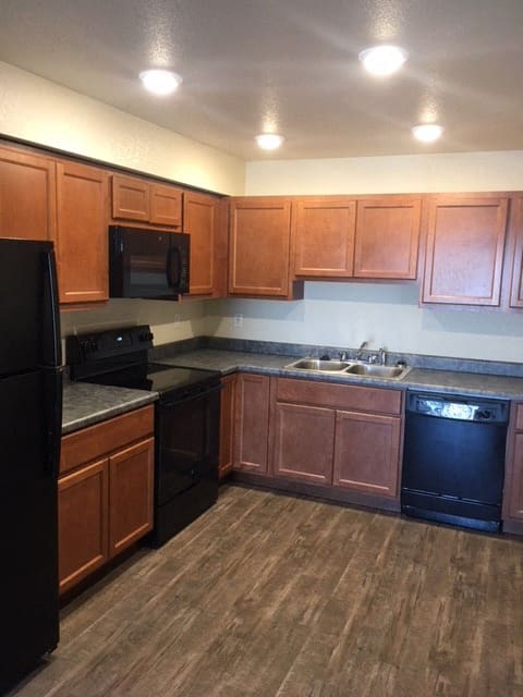 Image of refrigerator, microwave, stove, faucet, sink, stove, cabinet, and stove