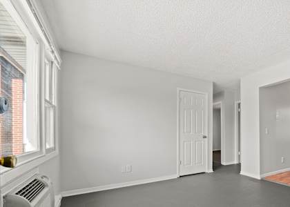 a bedroom with a large window and a radiator