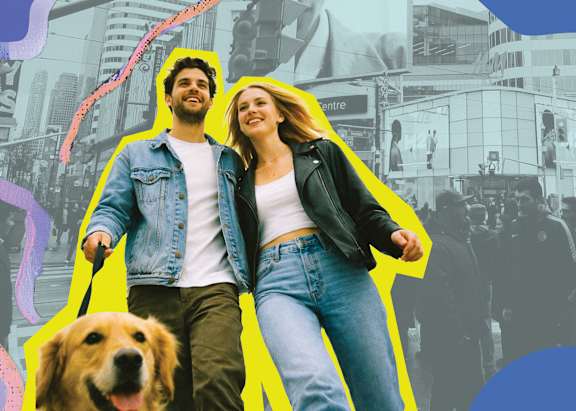A man and woman are walking a dog on a leash.