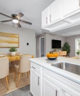 a kitchen and dining room with a sink and a ceiling fan