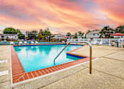 Thumbnail 3 of 5 - A swimming pool surrounded by a red brick border.