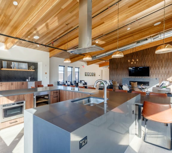 a large kitchen with a large island and wood ceilings