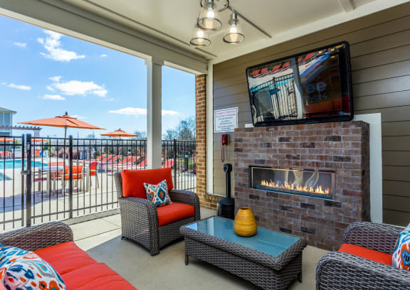 a living room with a fireplace and a tv on the wall