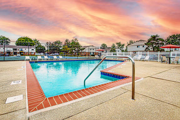 A swimming pool surrounded by a red brick border.