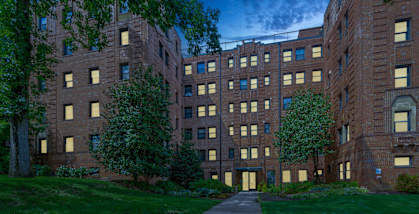a large brick building with trees in front of it