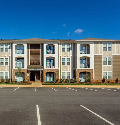a building with parking lot in front of it