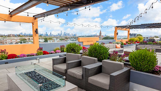 a seating area on the rooftop of a building with a view of the philadelphia skyline