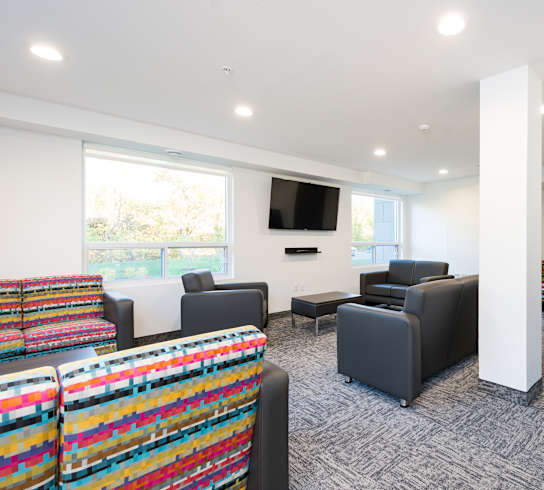 a living room filled with furniture and a flat screen tv