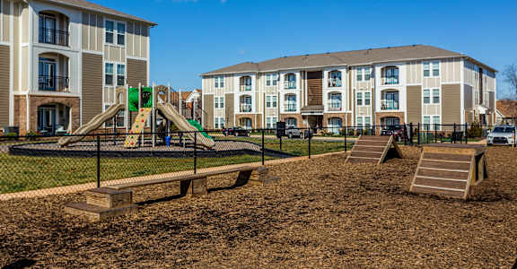 a playground in front of an apartment building