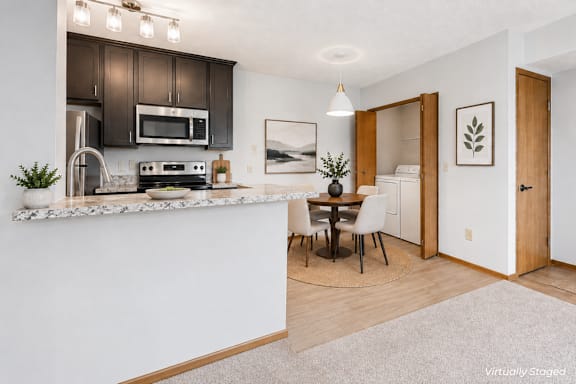 a kitchen and dining room with a table and chairs
