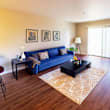 A living room with a blue couch and a coffee table.