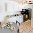 A kitchen with a table set for two.