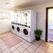 A laundry room with a washing machine and dryer stacked on top of each other.