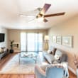 A living room with a ceiling fan and a couch.