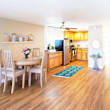 A dining room with a table and chairs.
