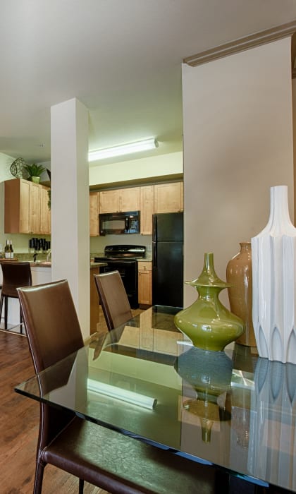 a living room and dining room with a glass table