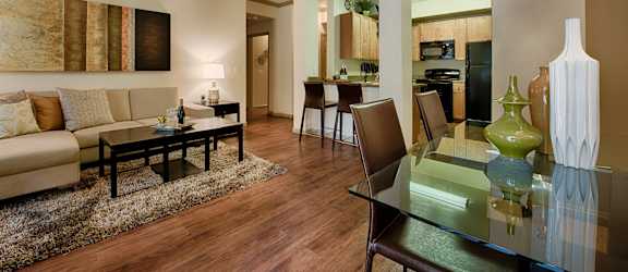 a living room and dining room with a glass table