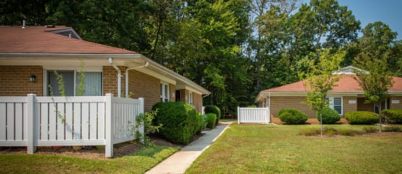 a house with a white fence in front of it
