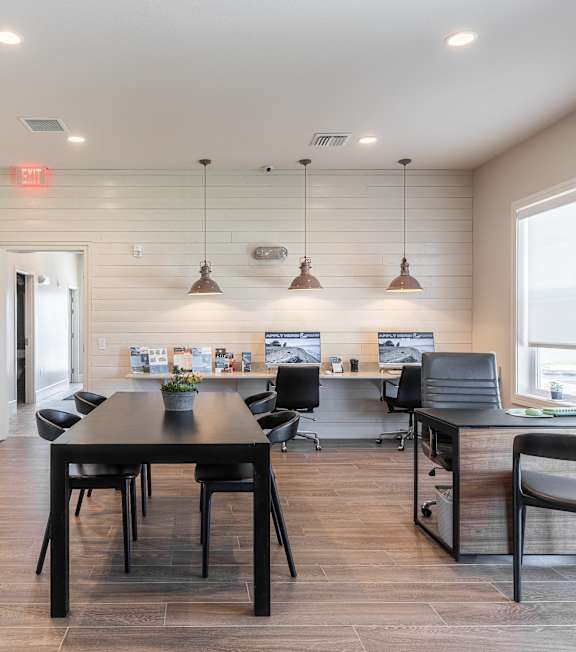 A modern kitchen with a dining table and chairs.