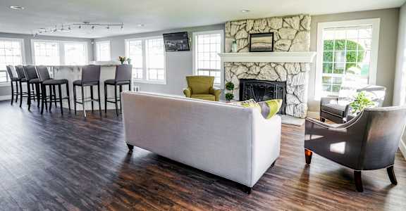 a living room with a couch and chairs and a fireplace