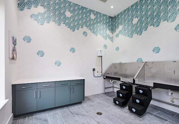 a kitchen with a large sink and a counter with two refrigerators