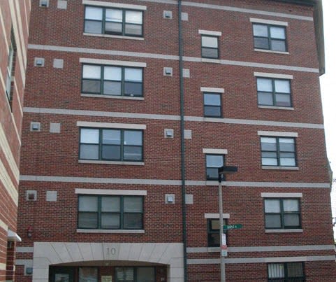 the front of a red brick apartment building